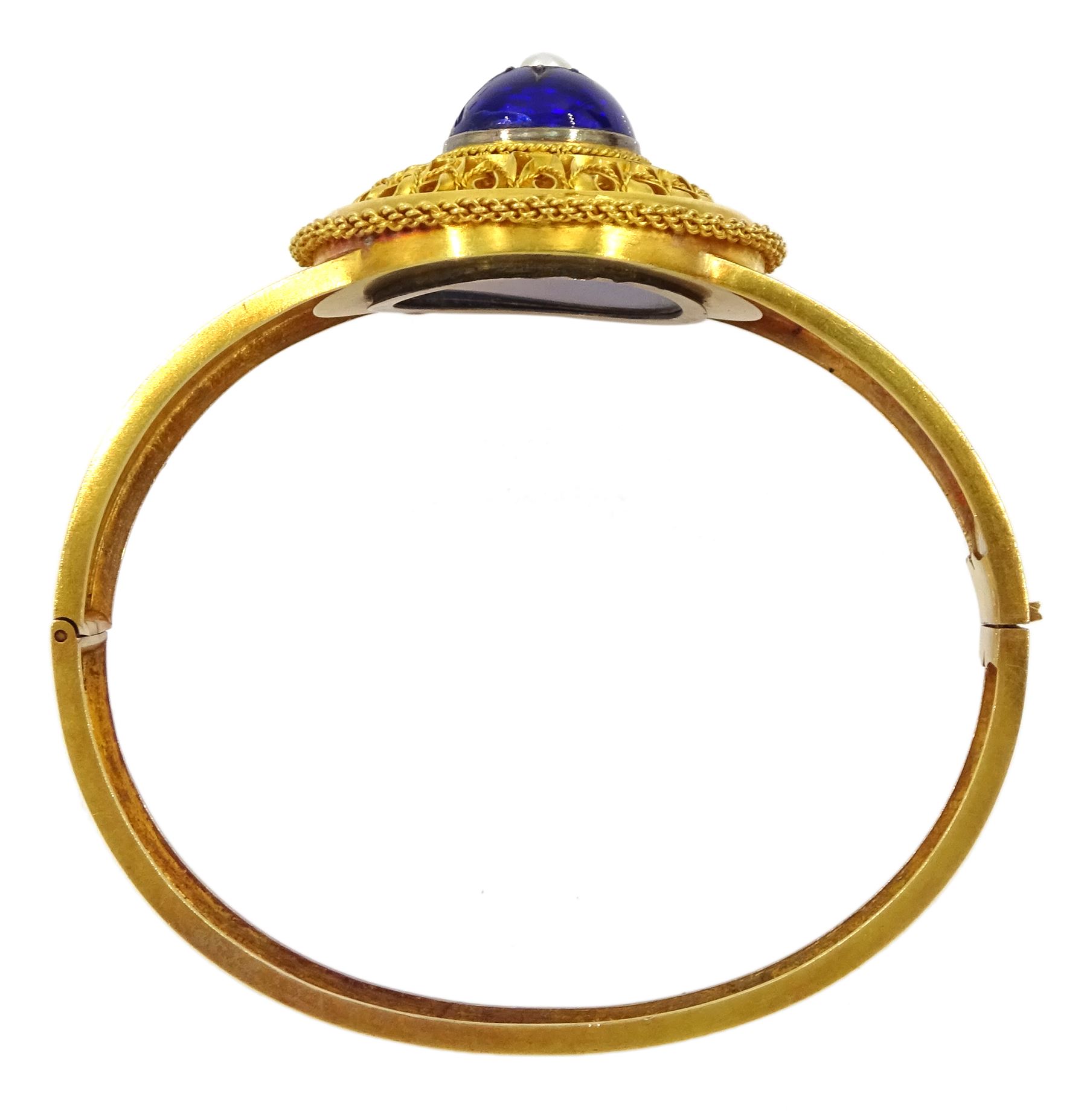 Victorian 18ct gold enamel and seed pearl hinged bangle and matching brooch, each star set with a seed pearl and blue enamel dome within a circular cannetille frame, each with a glazed panel verso, the hinged bangle with foliate engraved decoration, in fitted case