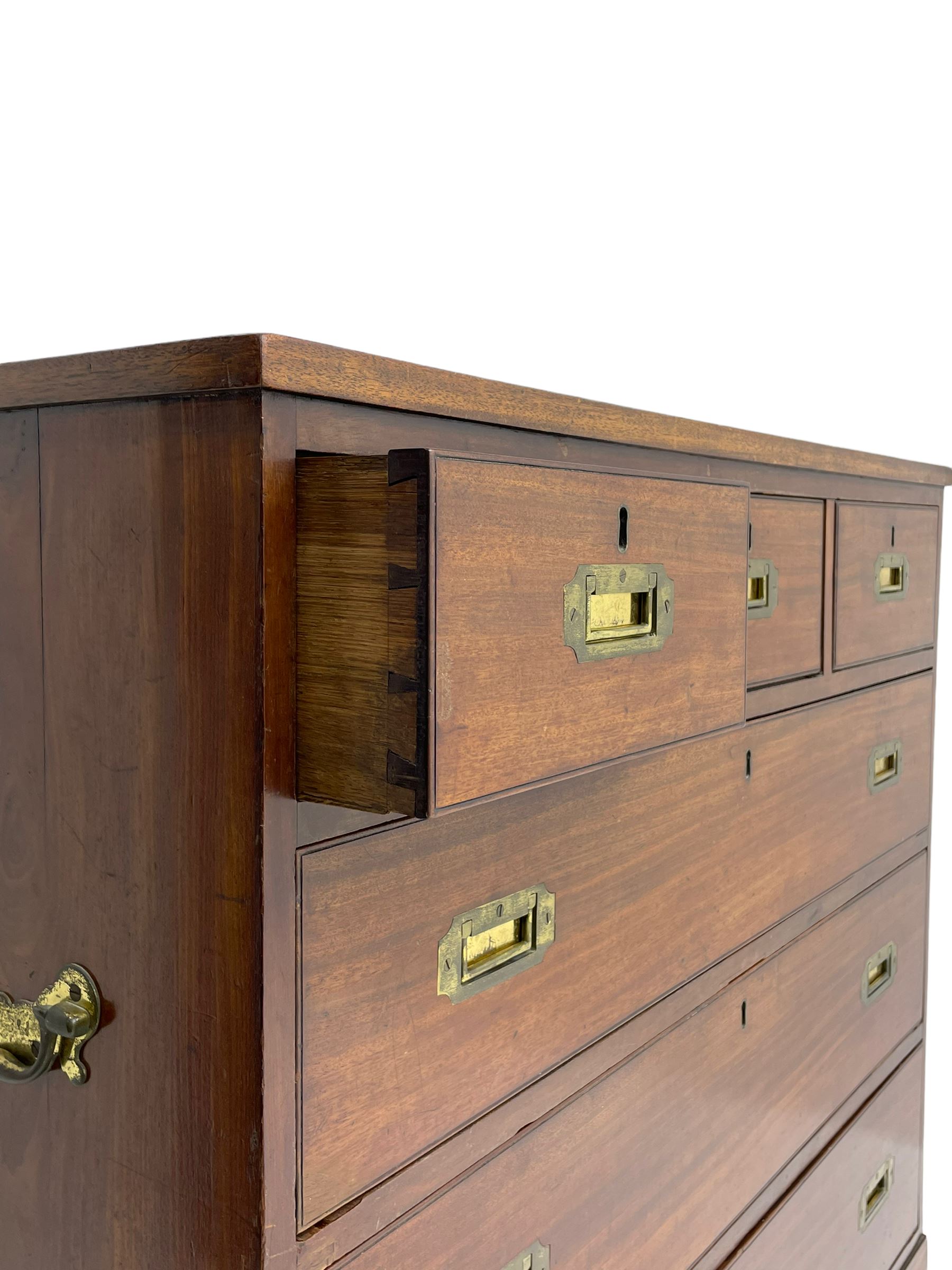 Georgian military type campaign chest, narrow rectangular top over three short and three long drawers, recessed brass handles, on bracket feet