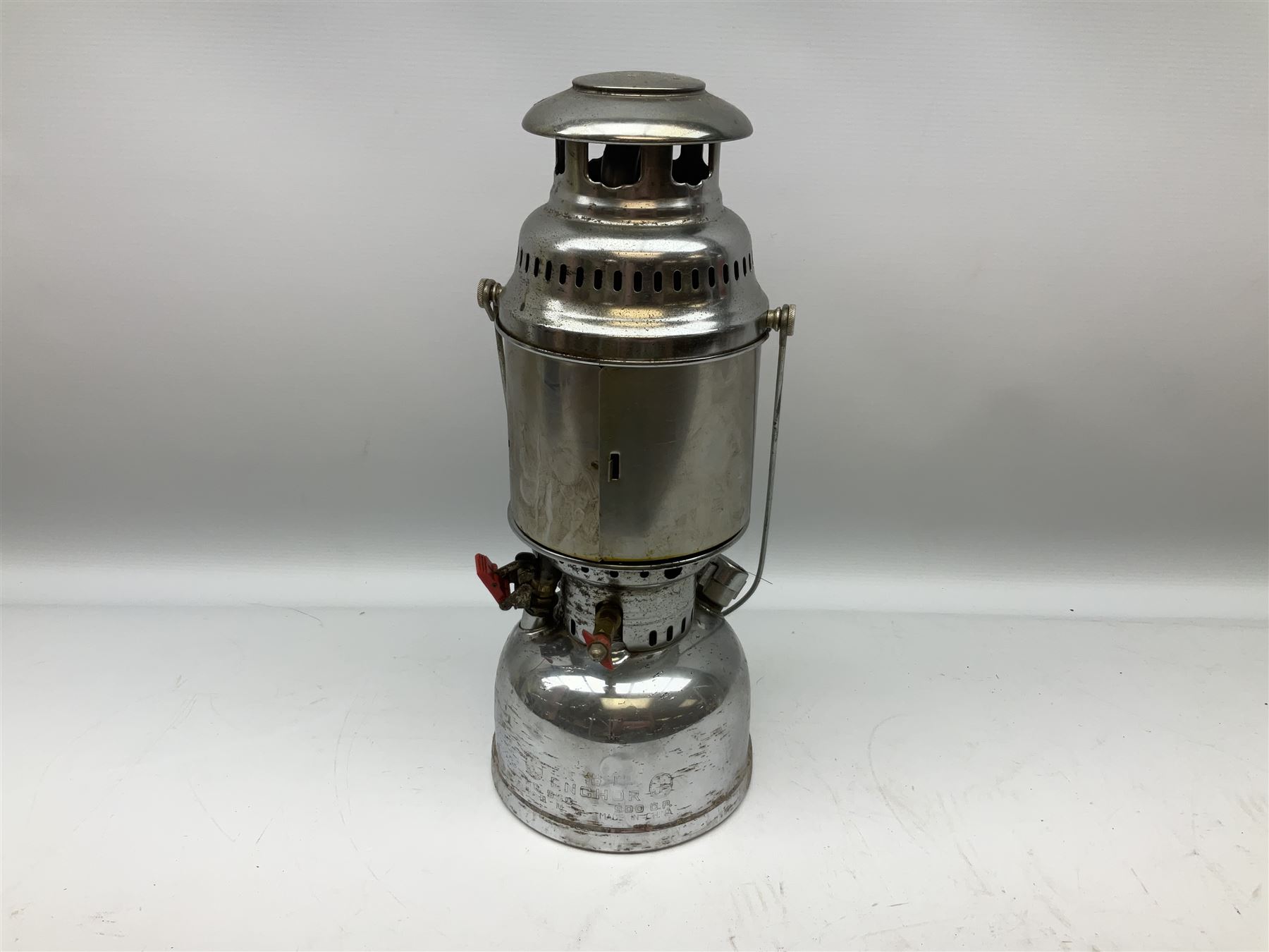 Copper and brass ship’s lamp marked ‘Anchor’, H25cm, Feuer hand storm lantern, Bialaddin Model 315 paraffin lamp and an Anchor lamp (4)