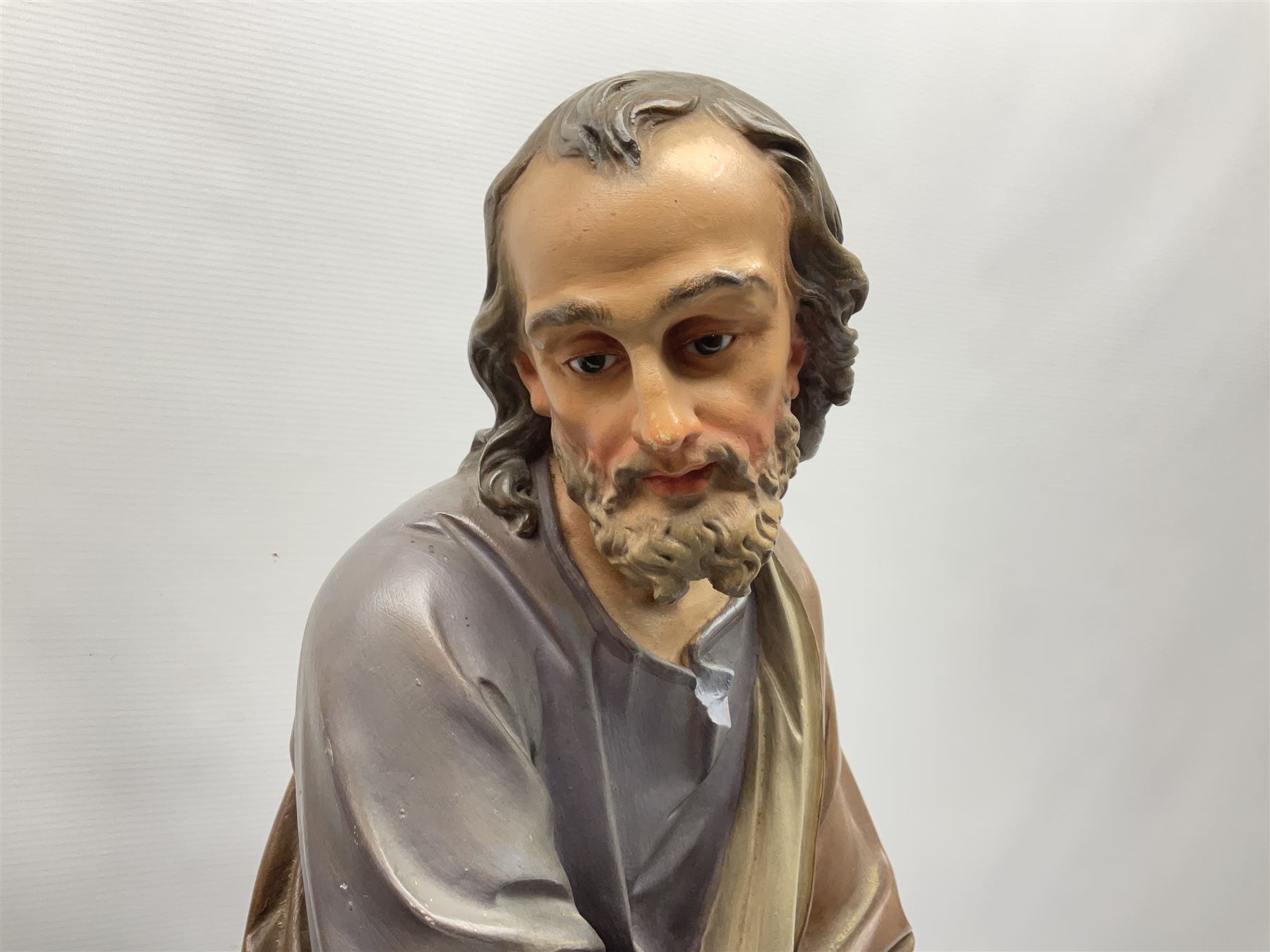 Two religious painted plaster figures of Mary and Joseph kneeling on oval plinths, with impressed mark 'Raffl et Cie Paris', H60cm 