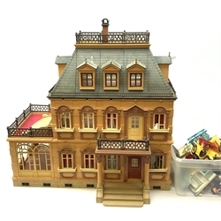  A child's Playmobil Victorian mansion dolls house, together with a good selection of accompanying playmobil characters and furniture.   