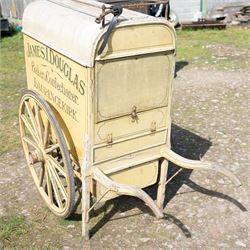 James I. Douglas, Baker & Confectioner, Laurencekirk Hand Drawn Delivery Cart

An attractive late 19th or early 20th century hand drawn baker's delivery cart, finished in cream and retaining its original hand painted advertising livery for James I. Douglas, Baker & Confectioner, Laurencekirk. The enclosed body features a curved roof with external luggage rail, rear access doors and internal shelving for the transport and delivery of bread, cakes and confectionery. Mounted on large wooden spoked wheels with iron tyres and fitted with shaped shafts for a single horse, this is a highly decorative and increasingly scarce example of a provincial tradesman's delivery vehicle, offering excellent display potential for collectors, museums, period interiors or commercial settings.

Features:
• Original hand painted signwriting for James I. Douglas, Baker & Confectioner, Laurencekirk
• Enclosed delivery body with curved roof and external luggage rail
• Rear opening access doors with internal storage compartments
• Original internal wooden shelving and racks
• Large wooden spoked wheels with iron tyres
• Shaped shafts for single horse traction
• Builder's mark for Geo. Roberson Ltd., Wallington
• Decorative cream painted finish with period lining and detailing
• Suitable as a display piece, museum exhibit or advertising feature

Dimensions:
Overall length: 170 cm
Body length: 104 cm
Width: 83 cm
Height: 150 cm

Wheel Diameter:
Wheels: 95 cm