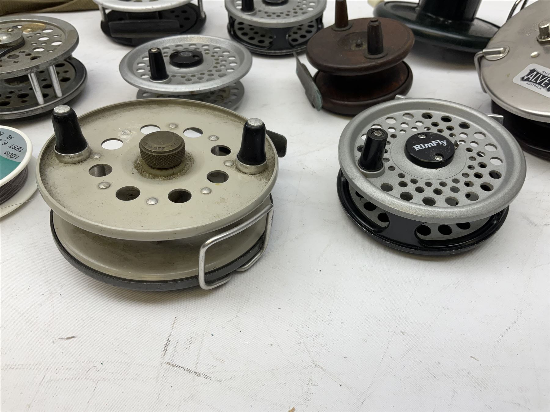 Fishing tackle, including 'The Gnat' fly reel, Alvey 4 1/2 inch reel, Paramount 4 1/2 inch reel, other fishing reels, various fishing flies and other similar items in a carry bag 