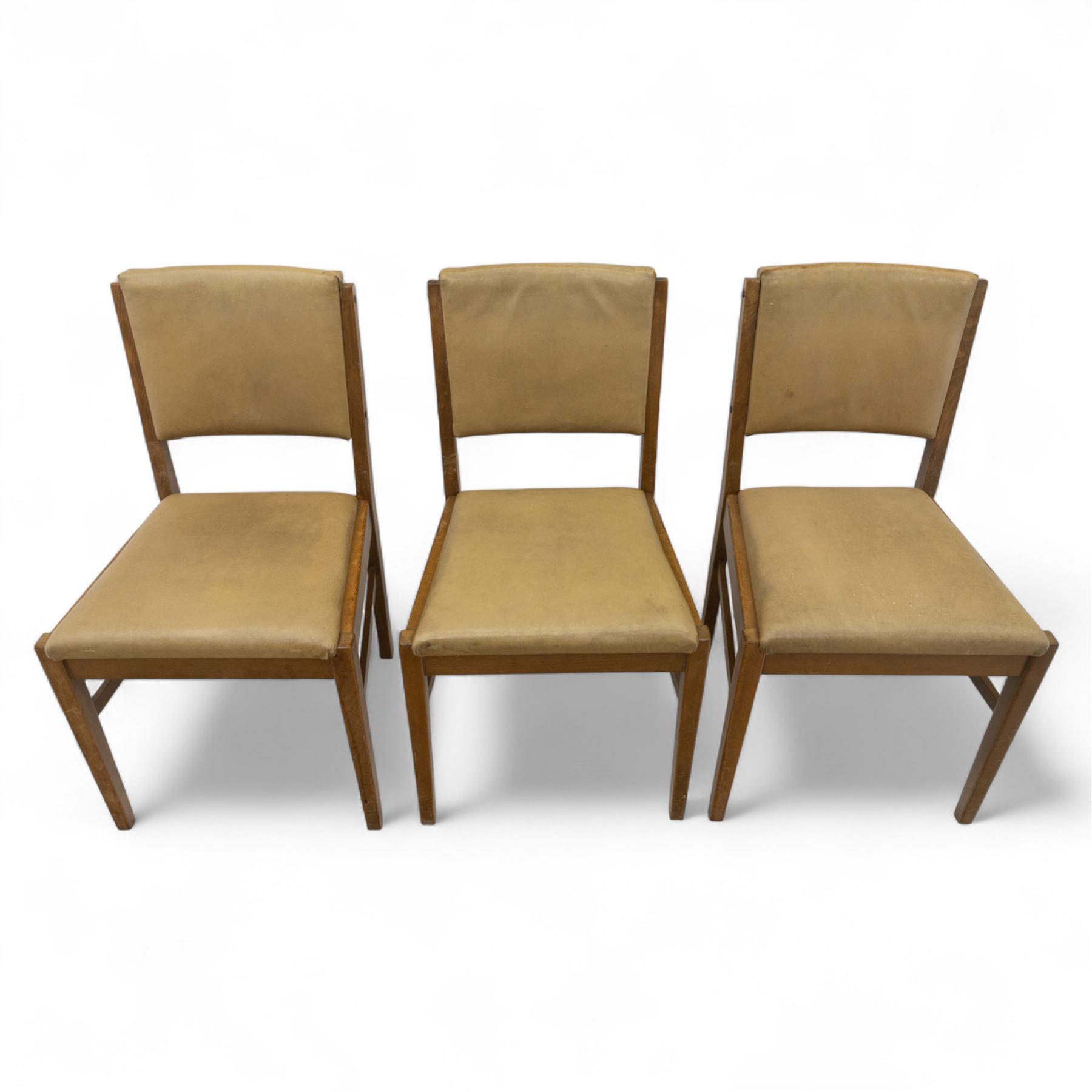 Gordon Russell - mid 20th century teak dining suite, comprising rectangular extending dining table and six matching chairs including one carver, each chair with padded upholstered seat and backrest in vinyl, on square supports, the table with plain top and rounded edges on tapered legs, an example of the firm’s functional post-war design with restrained modernist detailing (Chairs H 85cm, W 47cm, D 46cm) (Extends to 154cm)