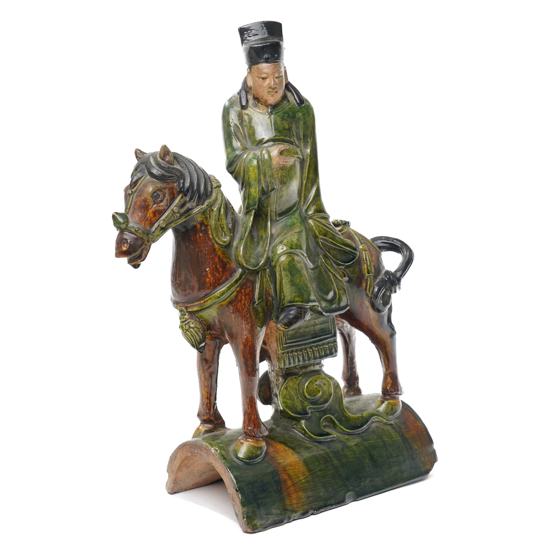 Chinese Ming dynasty Sancai Glazed Roof Tile, modelled as a dignitary on horseback, dressed in a long robe with voluminous folds, wearing an official's cap, upon a half cylinder tile, H40cm