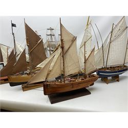 Eight model ships or boats including fishing boat with fish, nets and buoyancy aid, two mast sailing ship complete with cannons, two mast yacht with detailed rigging and life boat etc, the largest L72cm, H60cm