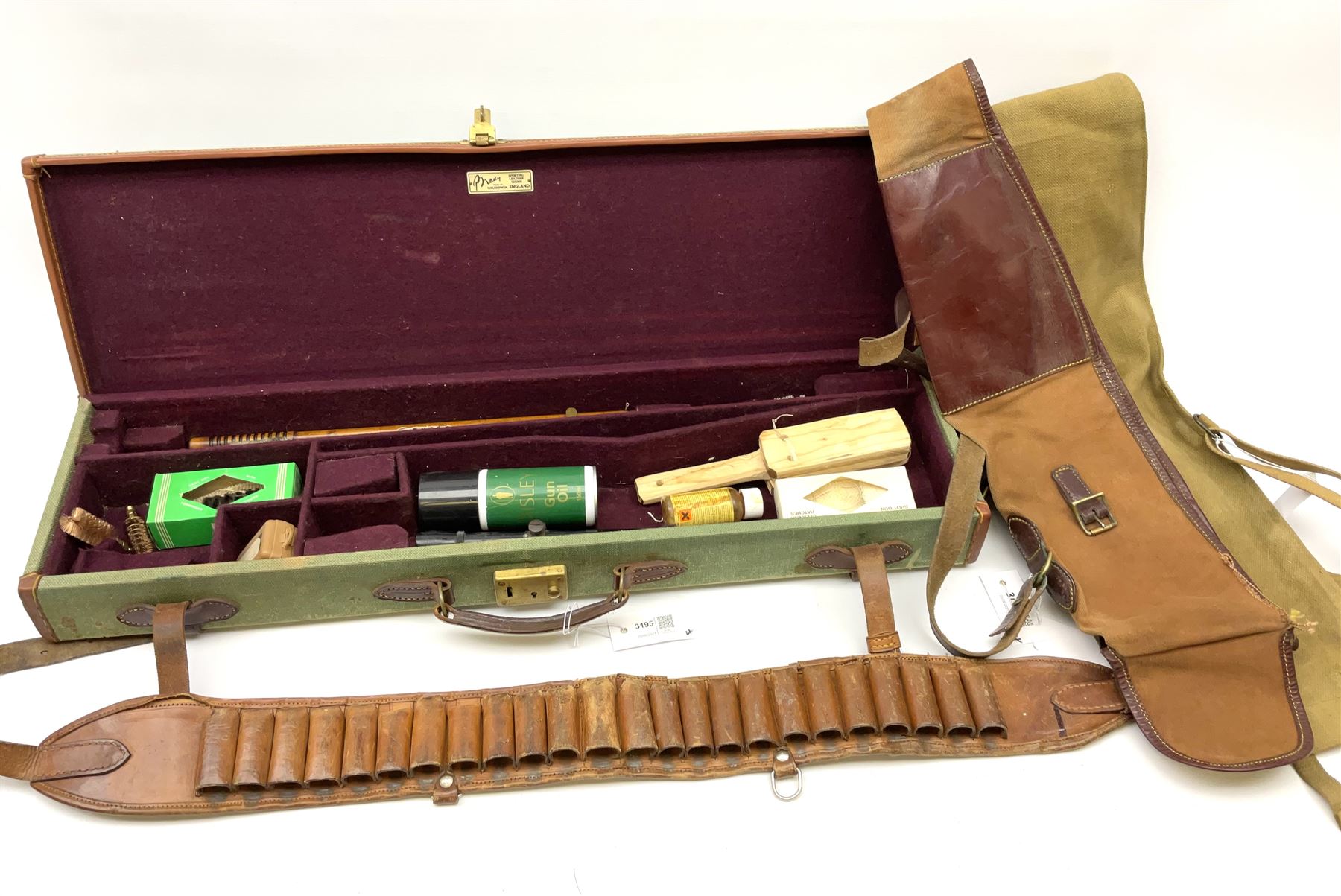 Brady leather mounted canvas shotgun case, the fitted interior to accommodate 71cm barrels, containing telescopic sight, bird scarer and assorted cleaning equipment L78.5cm; together with two canvas gun sleeves; and leather cartridge belt (4)