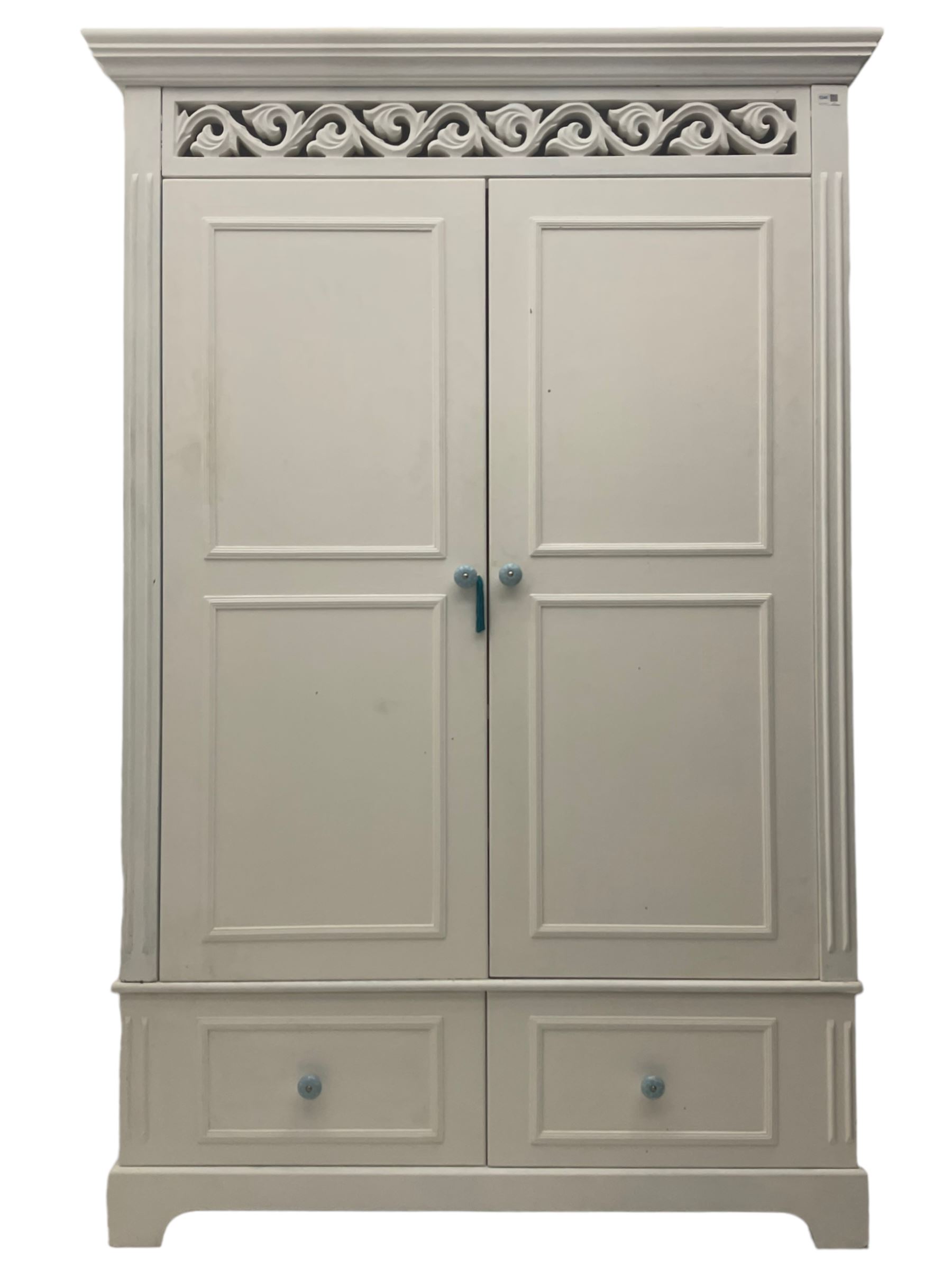 White painted double wardrobe, pierced scrolling foliate frieze over two doors enclosing hanging rail and two shelves, two drawers fitted to base, with blue ceramic handles