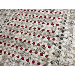19th century patchwork quilt, hand stitched from hexagons of various materials predominantly in neutral tones including printed floral examples, with alternating red and white striped centre, bordered in red, 190 x 238 cm