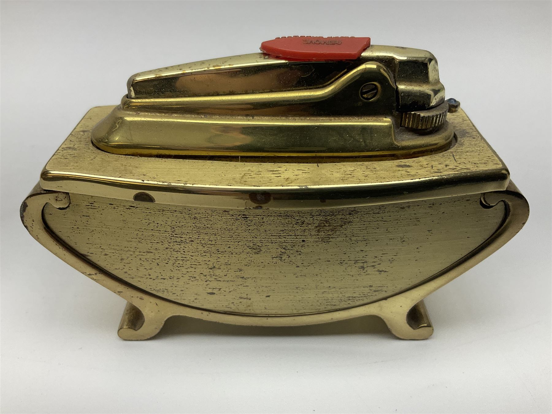 Ronson gilt metal table lighter, together with a silver-plate table lighter in the form of a football boot