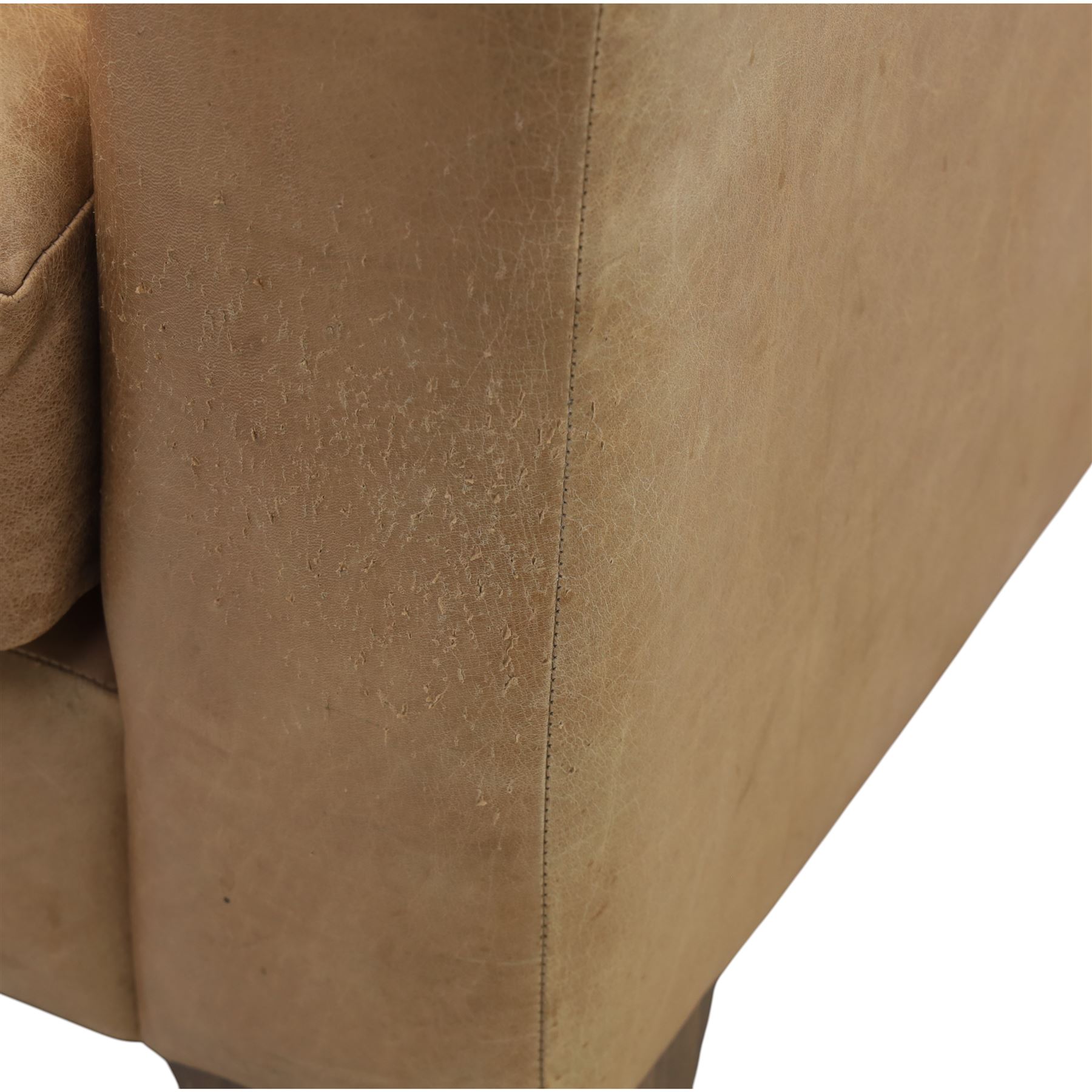 Modern two seat sofa in tanned leather, loose seat and base cushions, block arm rests above dark stained block supports 