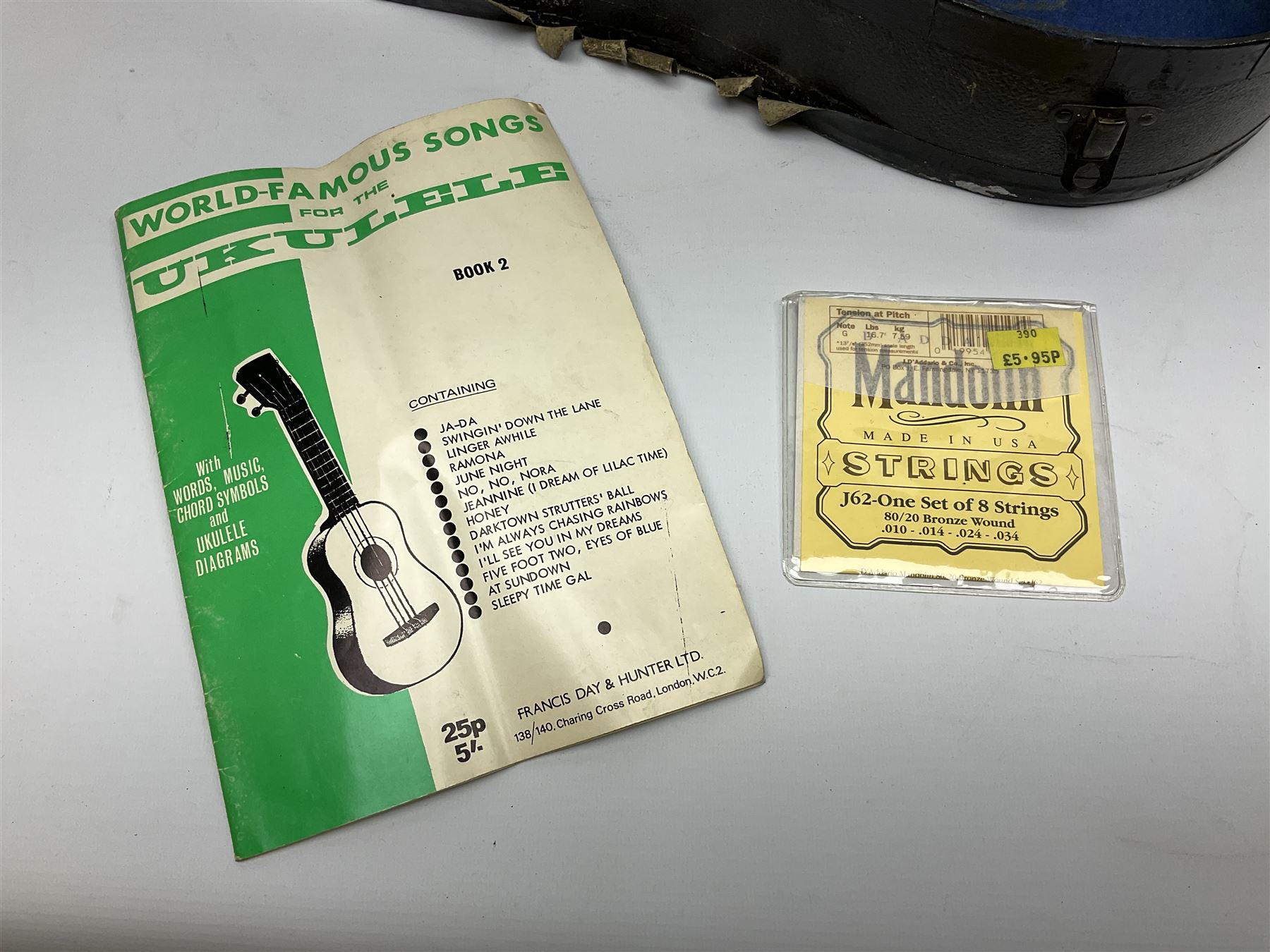 Dulcet eight-string banjo mandolin with mother-of-pearl inlaid ebonised fingerboard L55.5cm; cased; and Irish mahogany bodhran hand drum with inlaid stringing and vellum top D46.5cm; in soft carrying case with double ended beater (2)