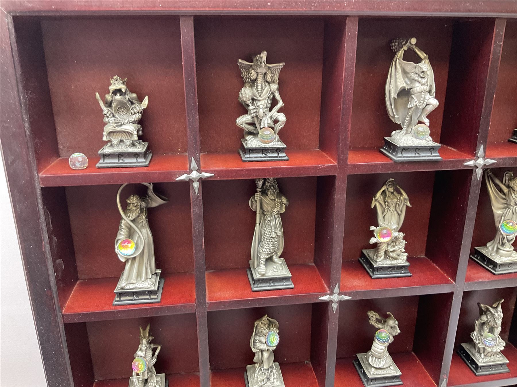 Danbury Mint 'The Fantasy of the Crystal' chess set consisting of mythical pewter chess pieces within a wooden case with chess board lid, together with 16 additional chess pieces in a wooden display case.