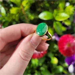 Early - mid 20th century gold jade ring, bezel set with a single oval cabochon jade of approx 4.10 carat, stamped 18ct