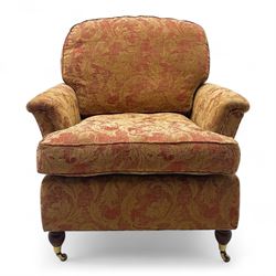 Duresta - Contemporary pair of upholstered armchairs, in red and gold damask style fabric, each with sprung seat and removable cushion back, rolled arms, on turned front supports with brass castors, square back legs 