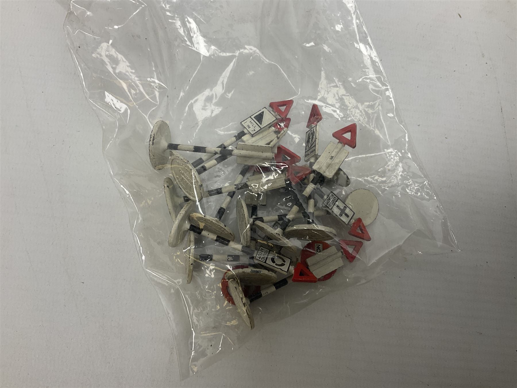 Dinky - over thirty unboxed and playworn die-cast models including Vega Major Luxury Coach, Peugeot 404, Humber Hawk, Ford Transit Van, Jaguar Type D etc; fourteen Dinky road signs; and quantity of other models including Budgie Supercar, Tri-ang Spot-On, Tekno etc