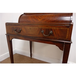 Edwardian mahogany cylinder front writing desk with three drawers, slide fitted interior and folding writing surface above a single frieze drawer, on square tapered supports with brass sockets and casters, the drawers lock when the slide is closed, W75cm, H102cm, D77cm    
