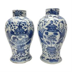 Pair of Chinese blue and white vases, of squat baluster form, each depicting figures holding a ginger jar, with four character Kangxi mark beneath, H13.5cm