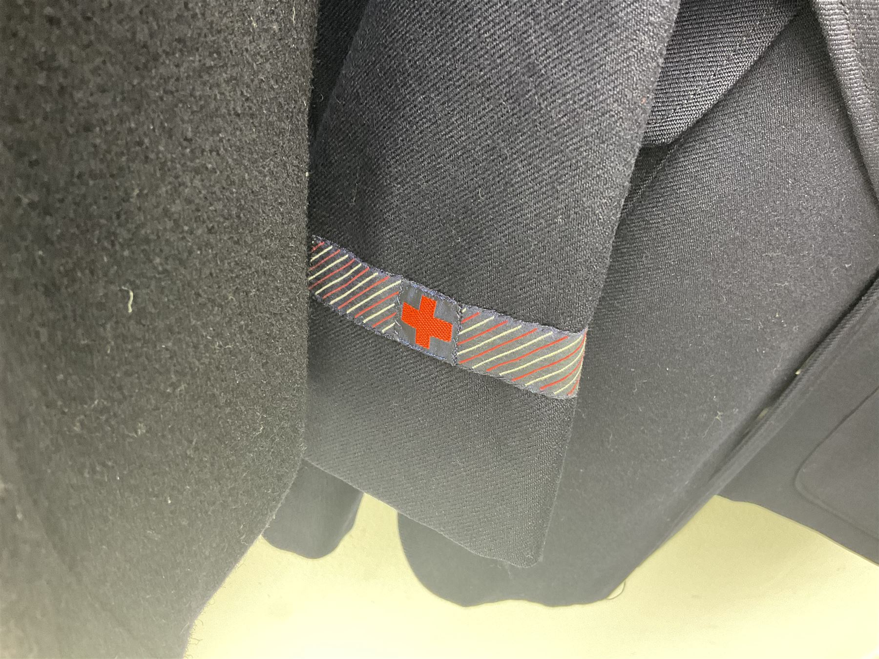 1950s British Red Cross North Yorkshire dress uniform comprising tunic, trousers, greatcoat and visor cap; bears manuscript label '1956 Ware'