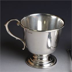 Two late 20th century silver christening mugs, each of plain form with no engraving, together with a small seal top spoon, all hallmarked 