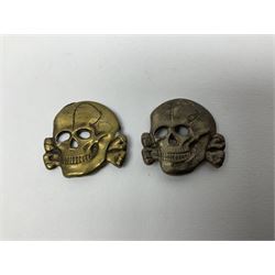 Five German 'SS' visor cap metal badges comprising one eagle and four skull and cross-bones (5)
