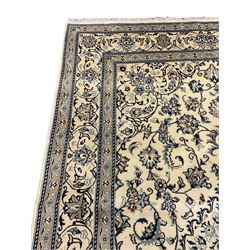 Central Persian Nain rug, wool with silk inlay, ivory ground decorated with scrolling and interlaced branch with stylised plant motifs, central floral medallion, triple band border with repeating design