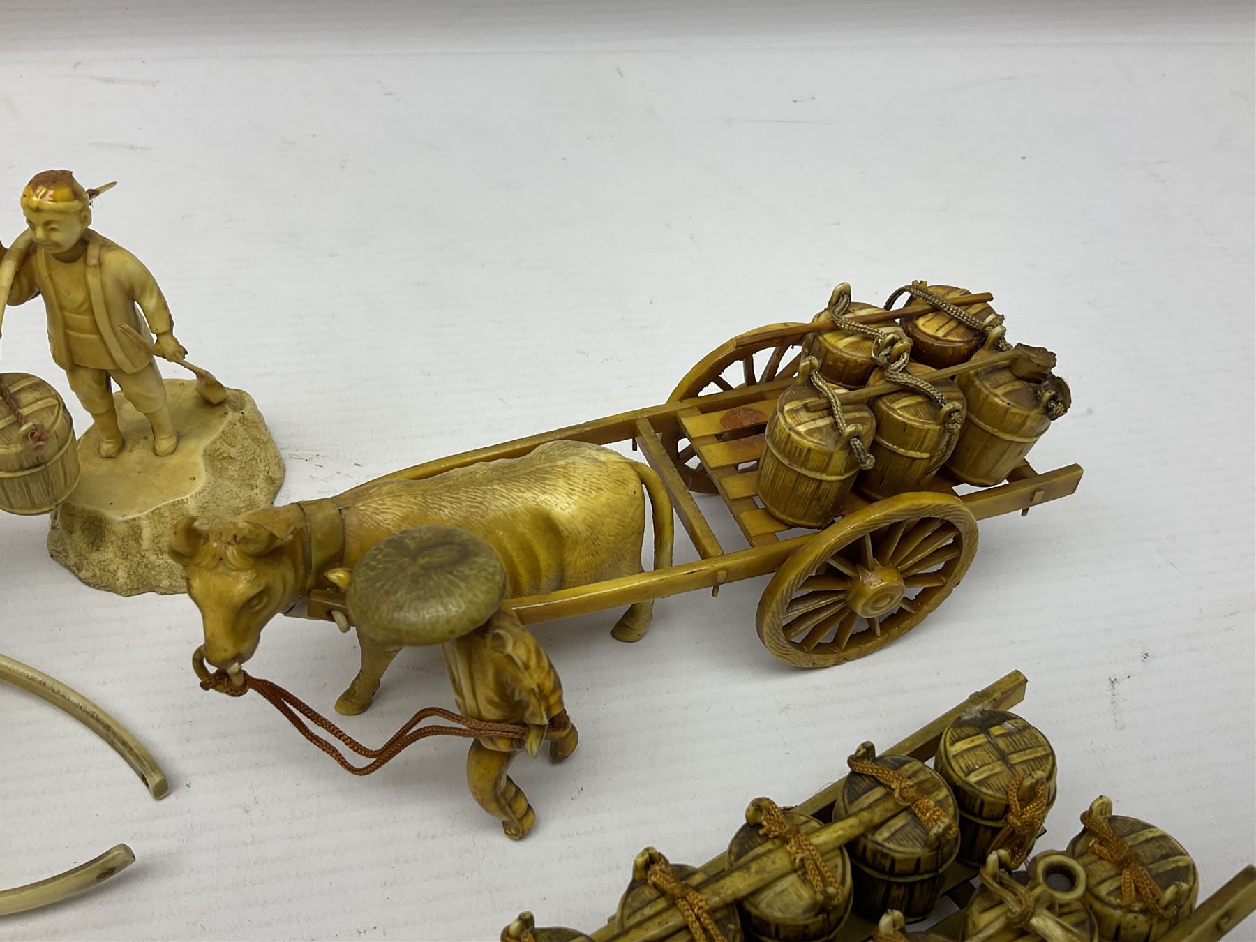 Collection of Japanese celluloid figures, including Rickshaw groups, fishing scene, oxen etc 