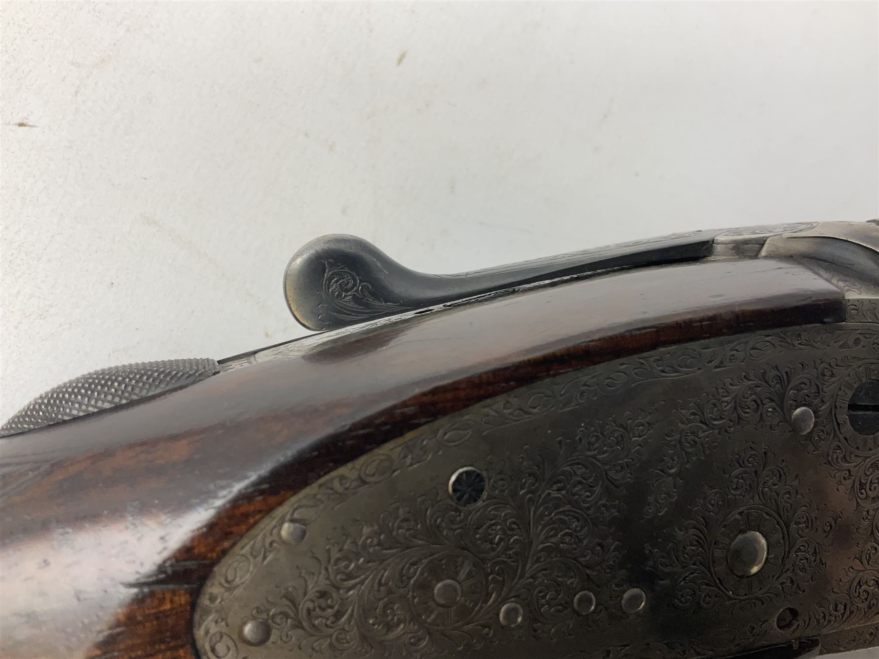 Smith Midgley Bradford 12-bore side-by-side double barrel side-lock ejector shotgun with 71cm barrels, engraved action with patented top lever, ivy leaf fences and top safety, walnut stock with chequered grip and fore-end, serial no.62409 to barrels and 1481 to action, L115cm overall SHOTGUN CERTIFICATE REQUIRED