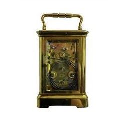 Late 19th century French carriage clock with a lever platform escapement, striking and alarm train and repeat button, in a gilt brass corniche case with an enamel dial, Roman numerals, minute track, steel moon hands and subsidiary alarm dial, eight-day movement striking the hours/half hours and alarm on two coiled gongs, movement backplate stamped G.L, trademark for Gay & Lamaille & Co, French clockmakers and wholesalers, c1880. 