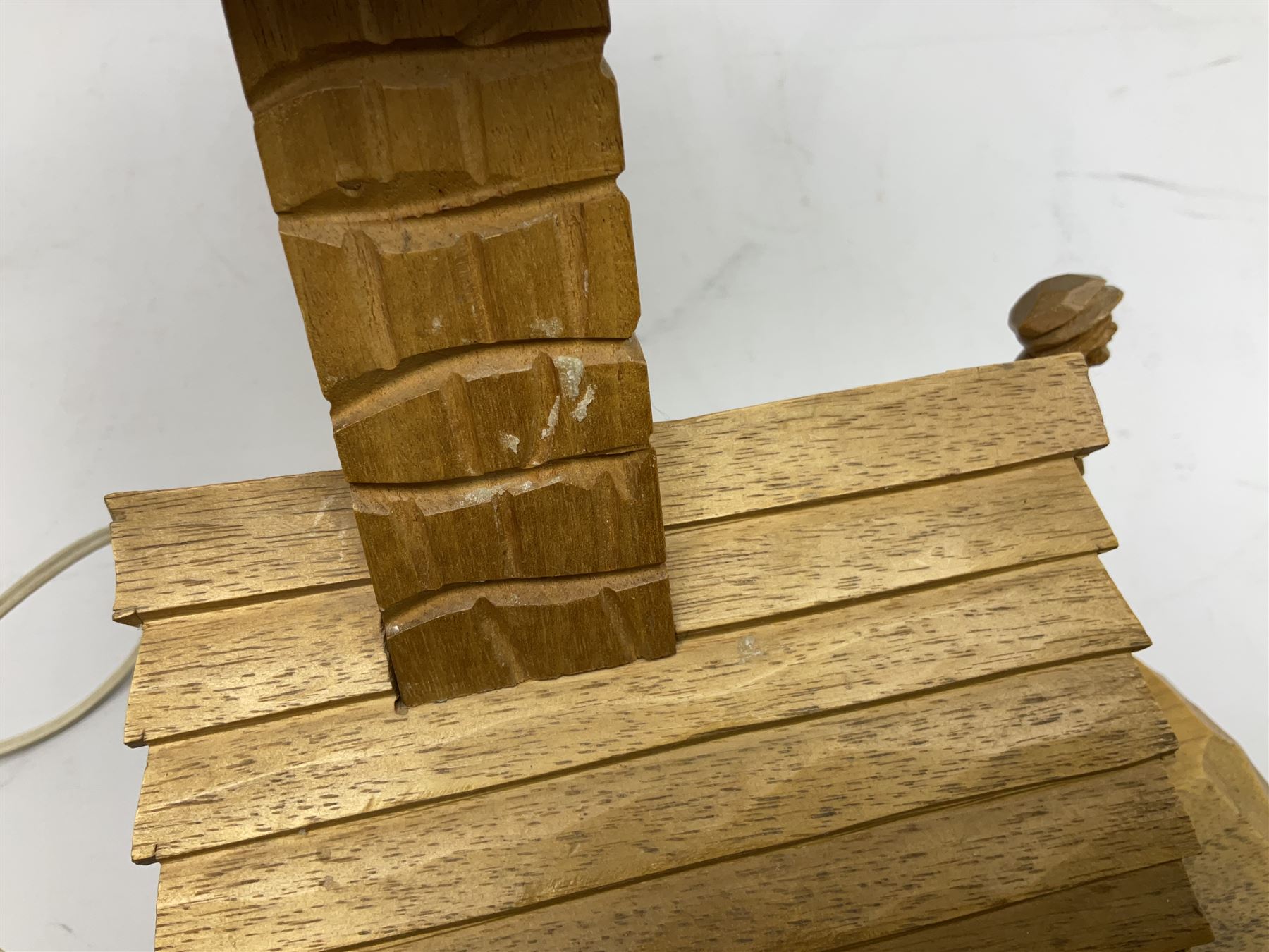 Mid 20th century Paul Caron carved table lamp, modelled as man standing before an oven, the chimney supporting the panelled shade, the base signed P.E. Caron, H42cm