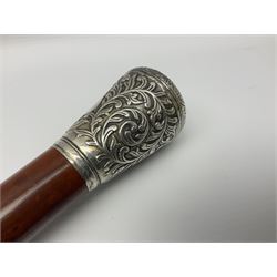 Victorian silver topped walking cane, possibly Anglo Indian, with chased petal design to top, the sides embossed with crowned vacant cartouche surrounded by foliate scrolls, unmarked, upon a Malacca shaft, L94cm