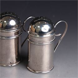 Pair of Edwardian silver muffineers, of cylindrical form with C scroll handles and removable pierced covers, hallmarked G E Walton & Co Ltd, Birmingham 1906, H6cm