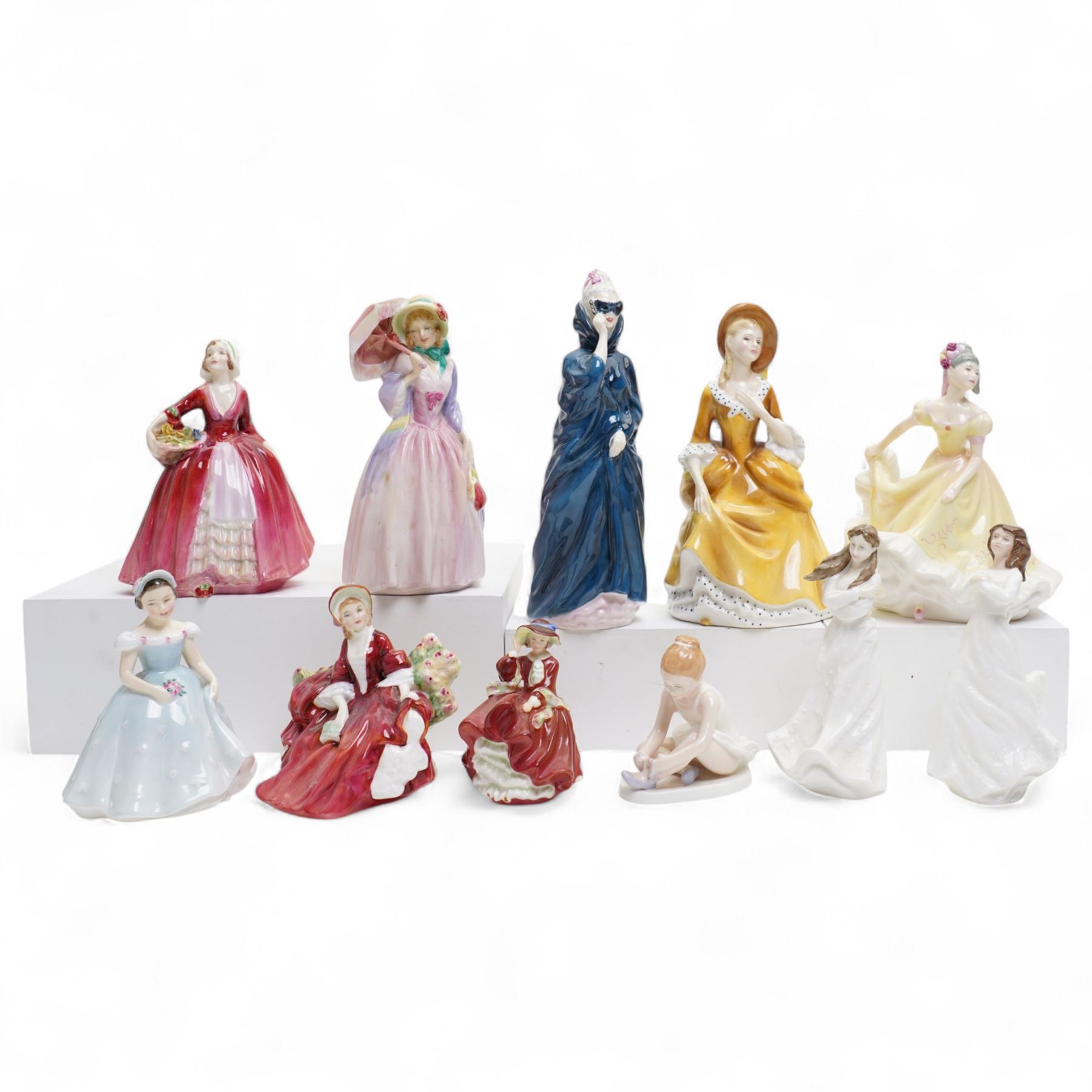 Eleven Royal Doulton figures, including Miss Demure HN1402, Ninette HN4717, Janet HN1537, Embrace HN4258 etc 
