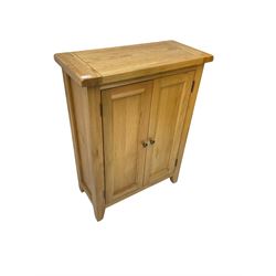 Solid light oak cupboard, fitted with two panelled doors enclosing two shelves, on tapered feet
