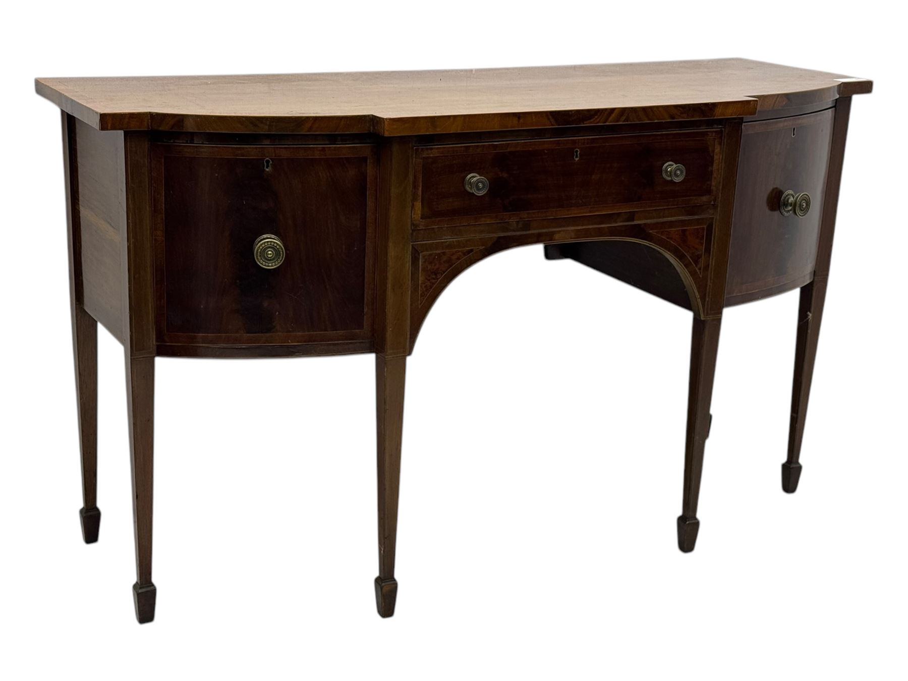 George III mahogany bow-fronted sideboard, serpentine-shaped top with crossbanded and boxwood stringing, over a central drawer flanked by deep cupboards, on square tapering supports terminating in spade feet