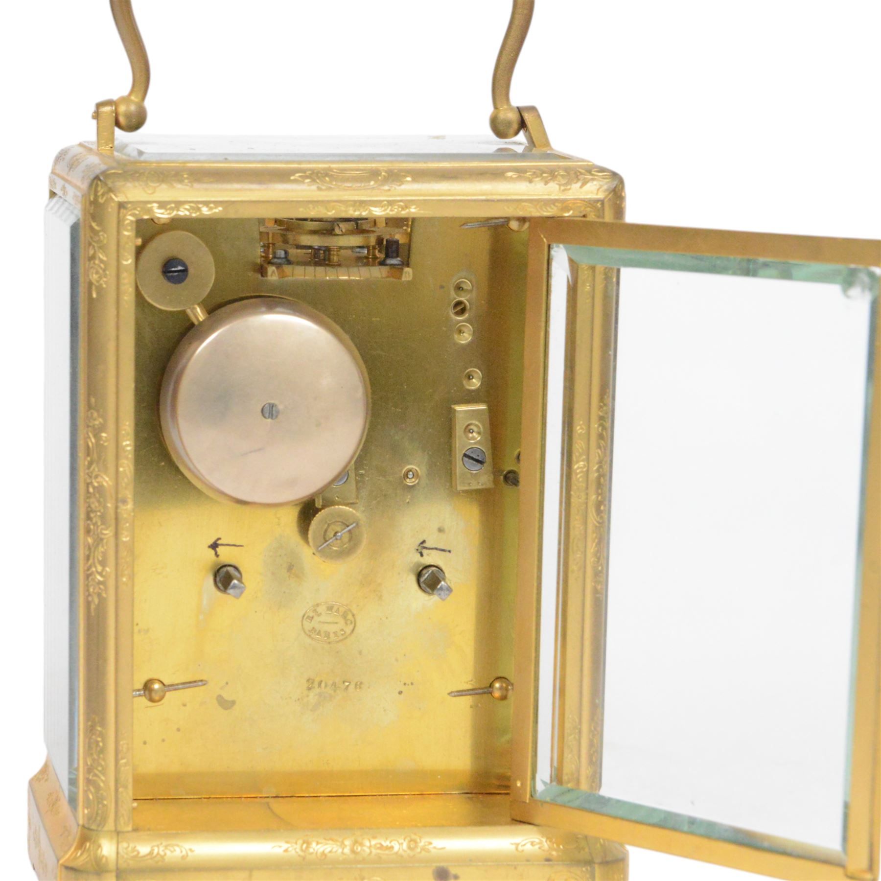 Late 19th century French 8-day brass cased carriage clock, Henry Marc of Paris, the gorge case with swing handle and four bevelled glass panels, white enamelled dial with Roman numerals and minute markers and steel hands, the two train movement with platform lever escapement, hour striking on a bell, with key