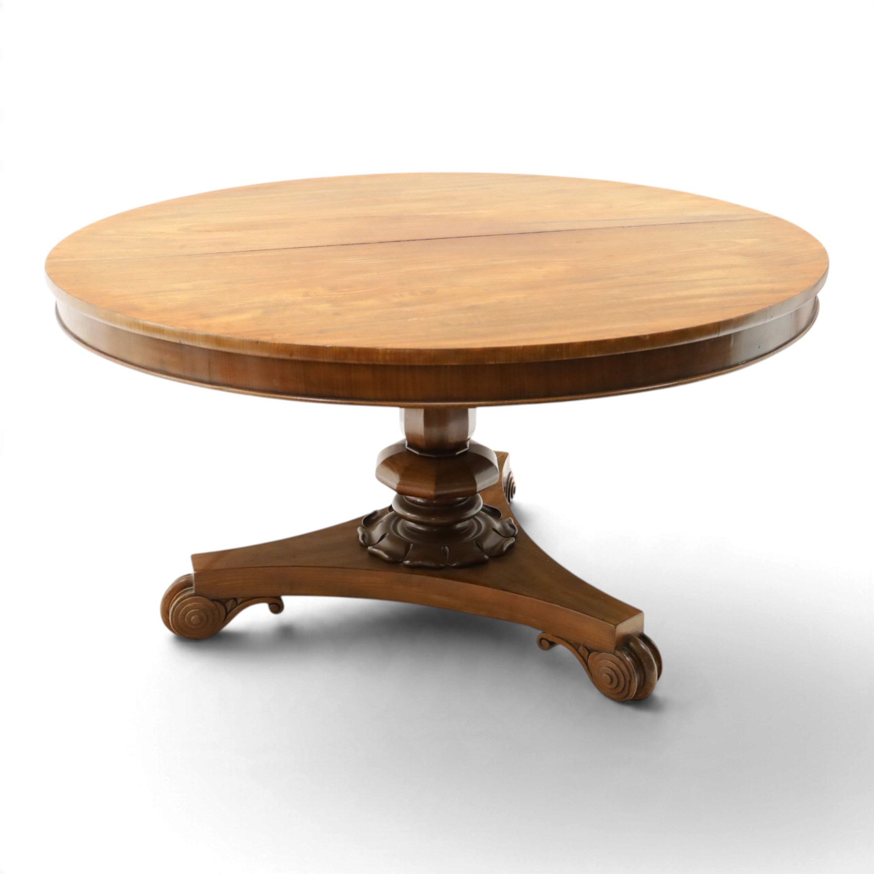 William IV mahogany circular breakfast table, banded frieze over a turned decagon pedestal with lappet carved collar, terminating to a triform platform base with scroll feet and castors