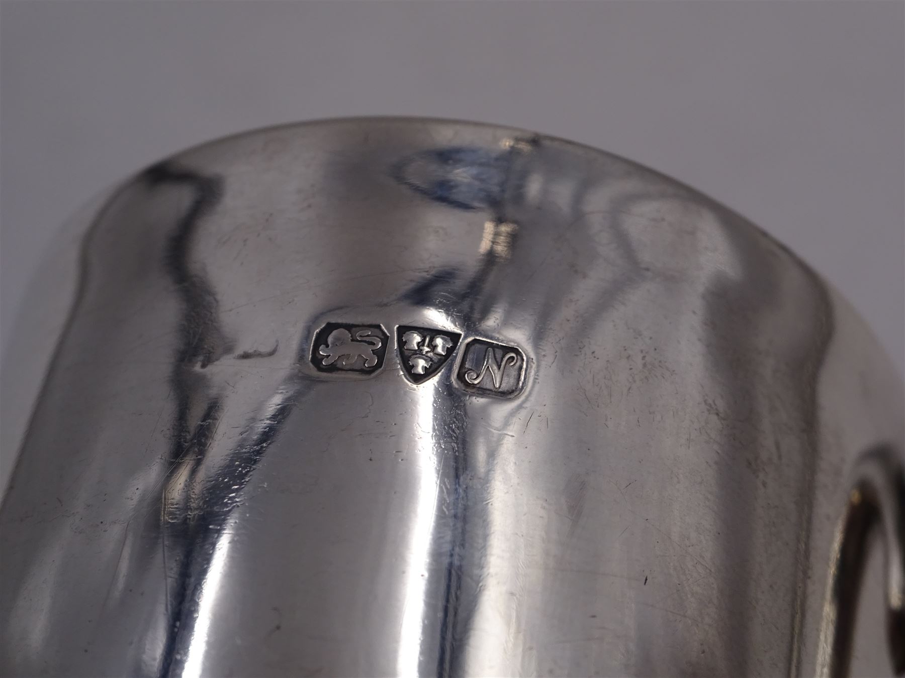 Early 20th century silver christening mug, of tapering cylindrical form, with C handle and personal engraving to centre, upon stepped base, hallmarked Chester 1913, maker's mark worn and indistinct, together with a Victorian silver christening mug, of slightly tapering form, with C handle, later personal engraving to centre and beaded rim to base, hallmarked James Dixon & Sons Ltd, Sheffield 1880, tallest H9cm