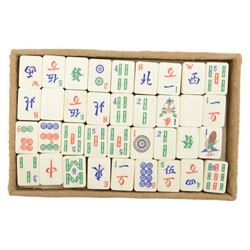 20th century Chinese Mahjong set, with five trays containing bone counters and tiles, contained within a leather bound travelling case with embossed detailing