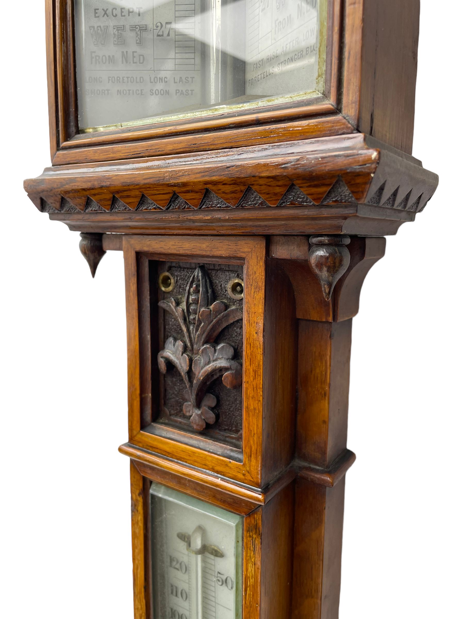 J Hicks - Hatton Garden London, - late 19th century carved oak cased Fitzroy barometer in a richly carved case with a carved crested pediment and square cistern cover, inverted opaline register reflecting FitzRoy's predictions and a scale from 27 to 31 inches of barometric pressure, with a thick bore cistern tube and adjustable rack and pinion twin vernier, fitted with a glazed snail bulb mercury thermometer recording the air temperature in both Fahrenheit and Celsius. Mercury clean and present.
James Joseph Hicks was born in Ireland, however, early in his life he moved to London where he was apprenticed to the instrument maker Louis P Casella. In 1860 he went into business in his own right as a scientific instrument maker at 8 Hatton Gardens. In 1864 he was granted membership to the British Meteorological Society and exhibited instruments at the Royal Society Exhibitions between 1876 and 1913. Hicks was one of London's most prolific and eminent barometer makers. 