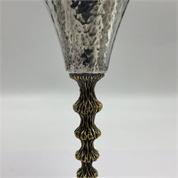 Pair of modern silver goblets by Stuart Devlin, the tapering cylindrical bowls each with spot hammered decoration and gilt interiors, the parcel gilt stems with signature textured detailing and six graduating knops, upon conforming spreading circular foot, hallmarked Stuart Devlin, London 1976, H17.7cm