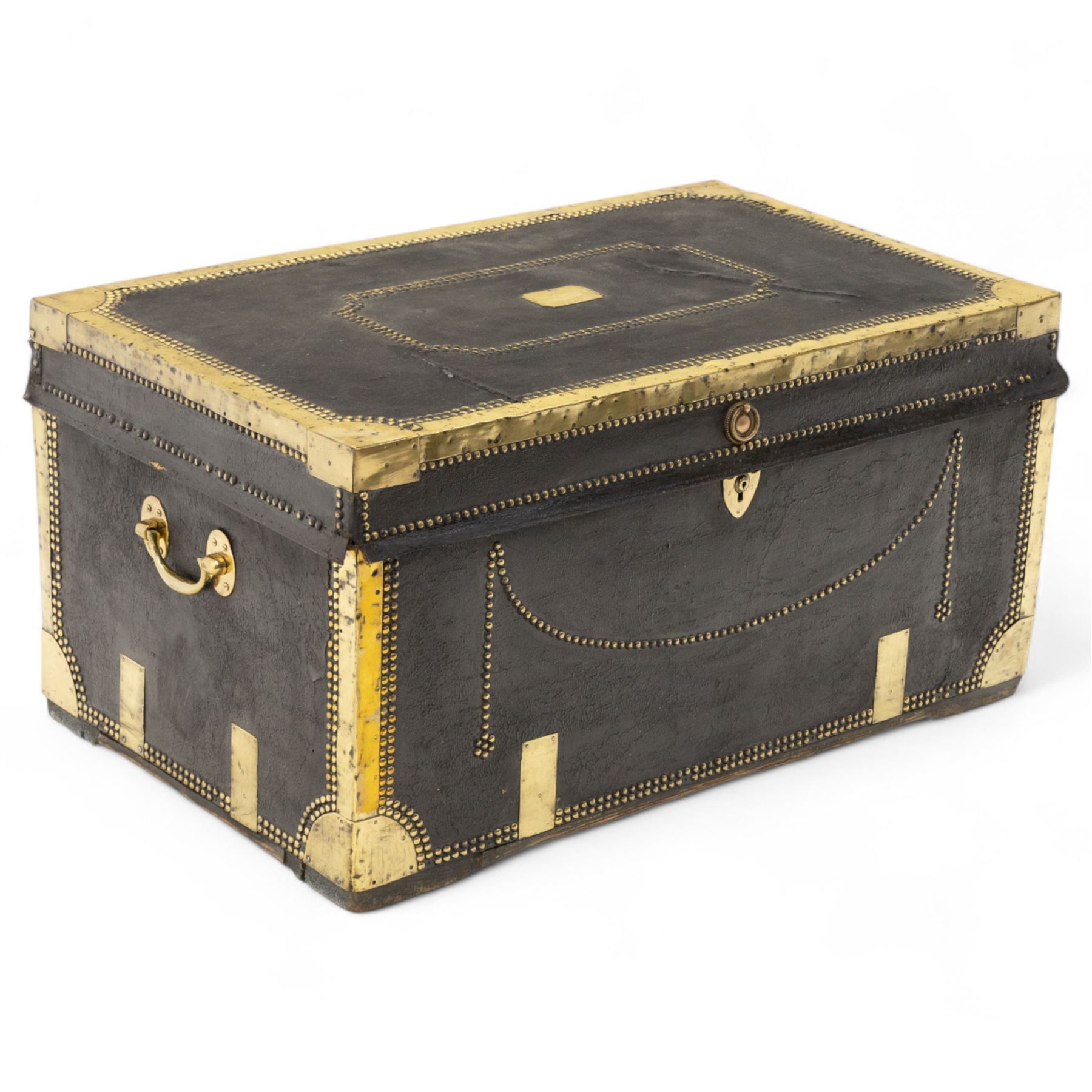An early 19th-century Georgian brass-bound travelling trunk, leather-covered exterior with brass stud work decoration, front with central brass lock plate, hinged lid with camphor wood interior, external sides fitted with large brass carrying handles 