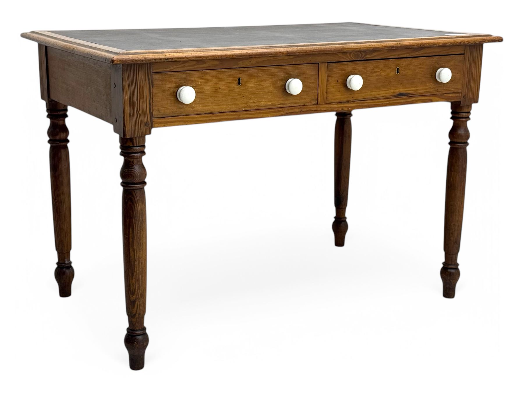 Victorian pine writing table, rectangular top with moulded edge and inset leather writing surface, the frieze fitted with two short drawers, raised by turned supports 