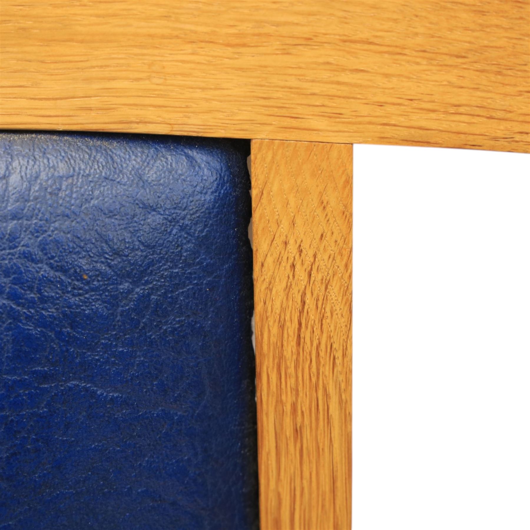 Modern twelve oak dining chairs including one 'Chairmans' chair, solid oak construction, slatted back and arm rests, blue leatherette padded seat, on tapered square supports 