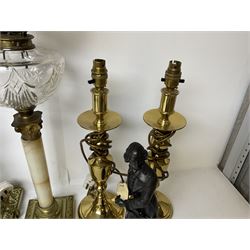 Oil lamp with frosted floral shade and cut glass reservoir, upon cast brass and marble base, together with a cast brass Corinthian column table lamp, pair of brass table lamps and a composite metal figure of a violinist 