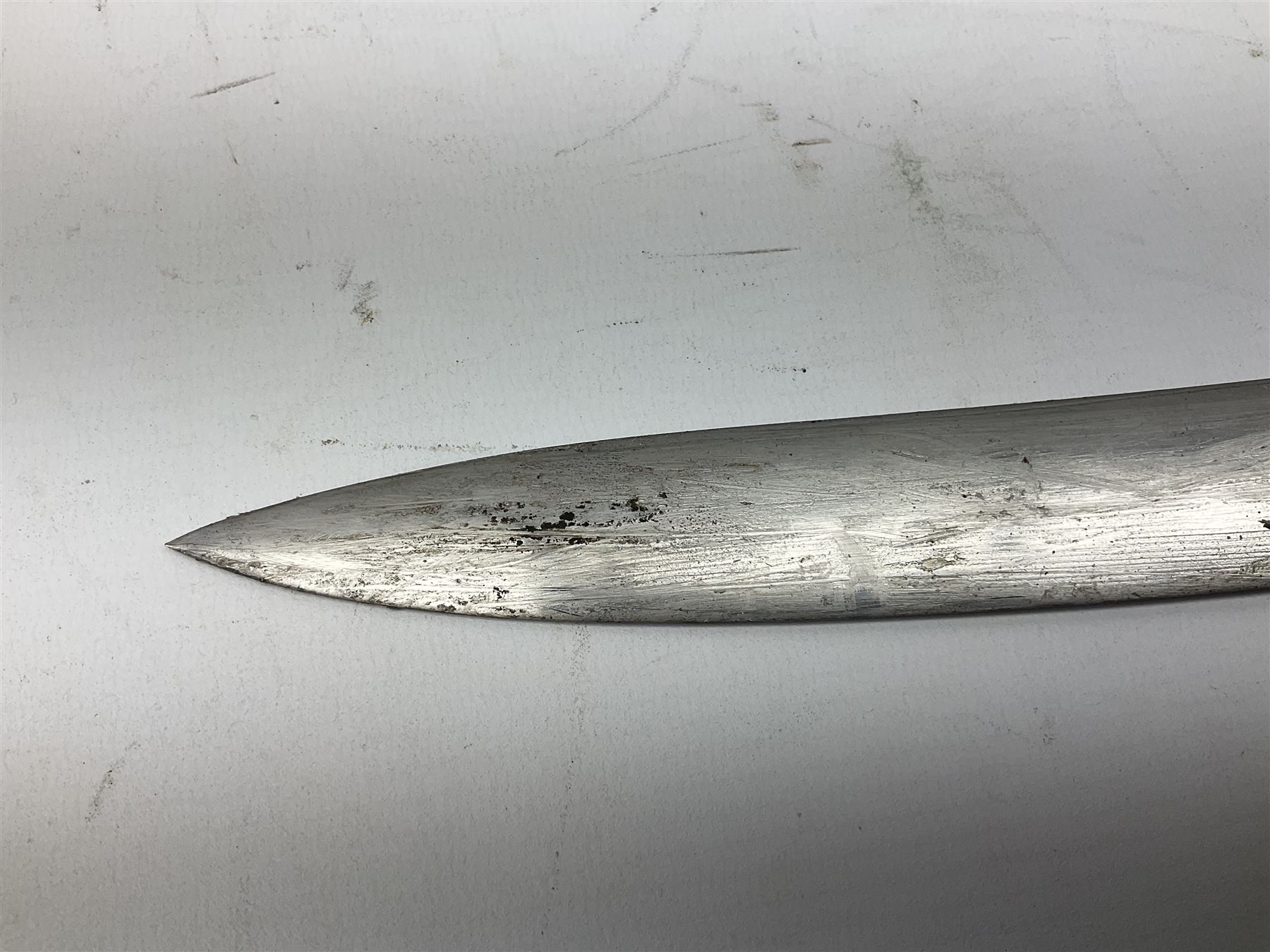 Turkish Model 1874 sword bayonet with 57.5cm curving steel fullered blade and chequered black grip, in steel mounted leather scabbard L75.5cm overall