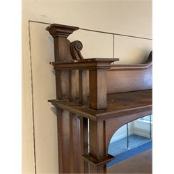 Late 19th century Arts & Crafts period oak mirror back sideboard, shaped bevelled mirror back carved with foliate scrolls and flower heads, down swept supports with elongated club-shaped uprights, moulded rectangular top over two drawers and three cupboards, the drawer fronts with copper handles decorated with sailing ships, panelled doors carved with mythical beasts, flowerheads and foliage, on moulded block feet