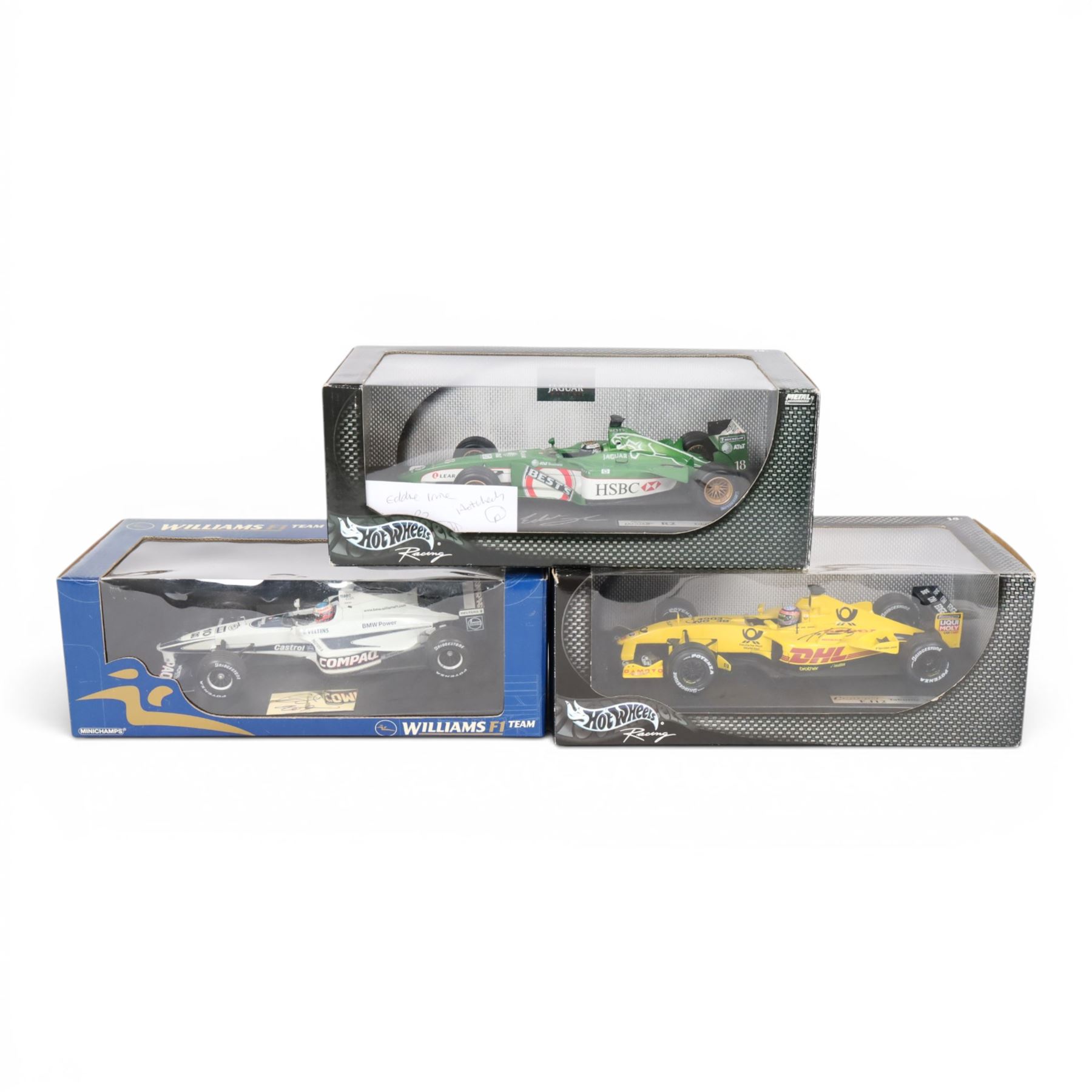 Three signed limited edition 1:18 scale Formula One models, comprising Hot Wheels Jordan EJ12 signed by Takuma Sato, Hot Wheels Jaguar Racing R2 signed by Eddie Irvine and a Minichamps Williams F1 Team model signed by Jenson Button, 1:18 scale model, all boxed