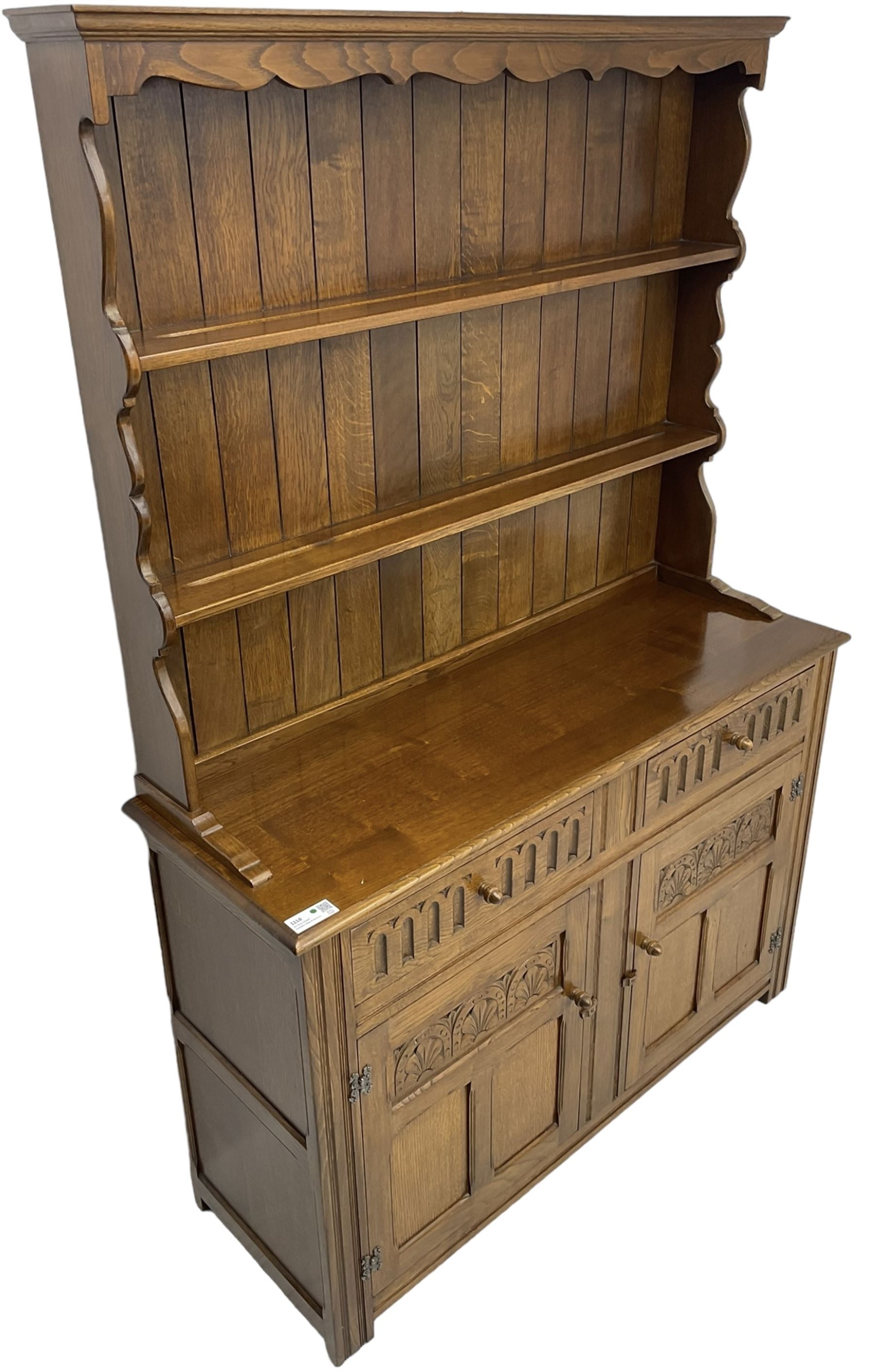 Mid-20th century oak dresser, raised two heights plate rack over two drawers and two cupboards