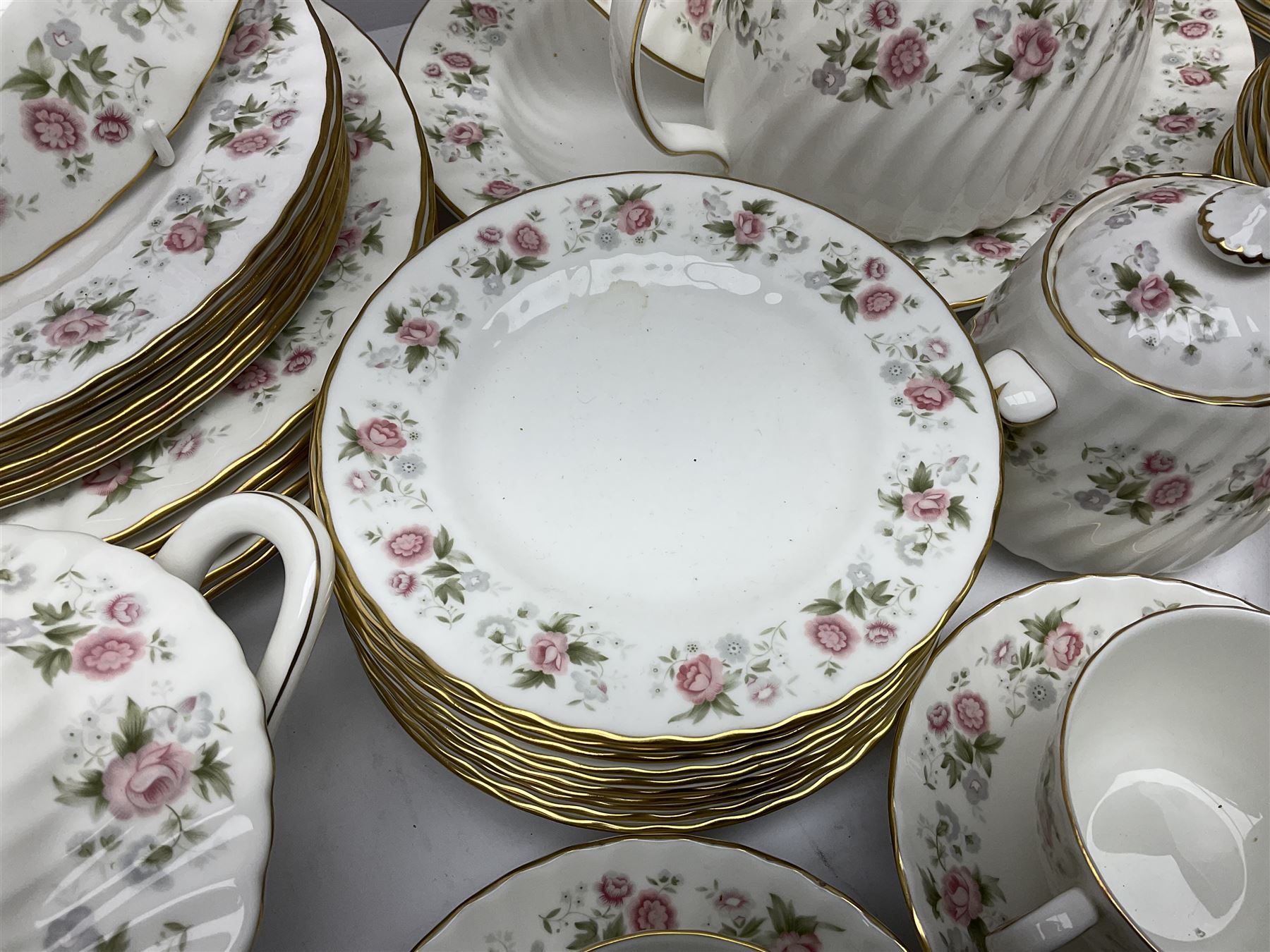 Minton Spring Bouquet pattern dinner and tea service, comprising dinner plates, twin handled tureens with covers, meat platter, teapot, milk jug, sugar bowl with cover, tea cups and saucers, bowls, cake plate, side plates, dessert plates, etc all with printed mark beneath (82)
